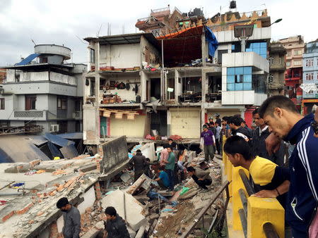 People survey a site damaged by an earthquake, in Kathmandu, Nepal, April 25, 2015.REUTERS/Navesh Chitrakar