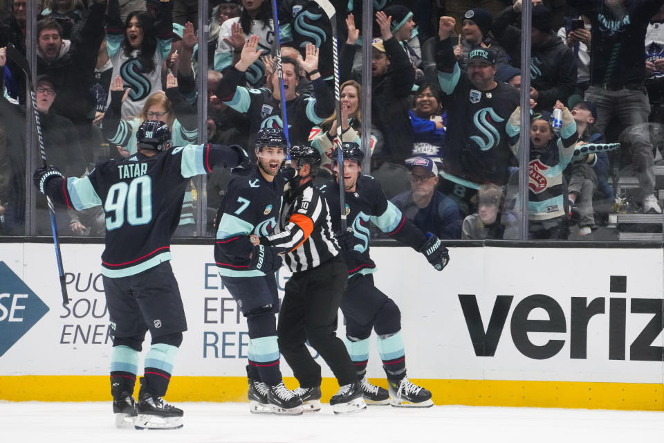 Seattle Kraken right wing Jordan Eberle (7) celebrates with left wing Tomas Tatar (90) and defenseman Brian Dumoulin, right, after scoring against the Toronto Maple Leafs during the second period of an NHL hockey game Sunday, Jan. 21, 2024, in Seattle. (AP Photo/Lindsey Wasson)