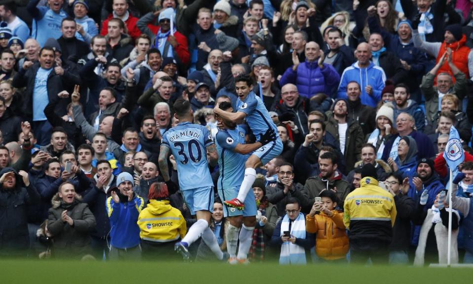 Britain Football Soccer - Manchester City v Chelsea - Premier League - Etihad Stadium - 3/12/16 Manchester City's Jesus Navas celebrates with Sergio Aguero and Nicolas Otamendi after Gary Cahill scored an own goal and their first Reuters / Phil Noble Livepic EDITORIAL USE ONLY. No use with unauthorized audio, video, data, fixture lists, club/league logos or "live" services. Online in-match use limited to 45 images, no video emulation. No use in betting, games or single club/league/player publications. Please contact your account representative for further details.