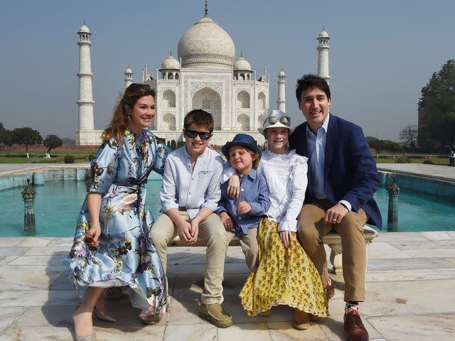 <p>MONEY SHARMA/AFP/Getty</p> Justin Trudeau, wife Sophie Grégoire and their three children pose for a photo at the Taj Mahal in 2018.