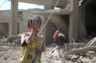 <p>A child is seen at debris of a building after a warcraft belonging to Syrian army targeted at Duma Town of East Ghouta, Damascus, Syria on August 22, 2016. (Halid Abu Jaafar/Anadolu Agency/Getty Images) </p>