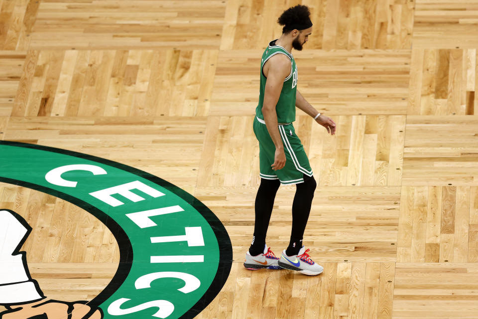 Boston Celtics guard Derrick White walks past the Celtics logo during the second half in Game 7 of the NBA basketball Eastern Conference finals against the Miami Heat Monday, May 29, 2023, in Boston. (AP Photo/Michael Dwyer)