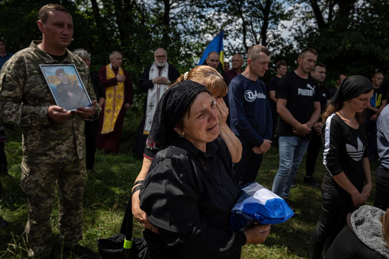 Maria cries during the burial of her son Bohdan Kobylianskyi (AP)