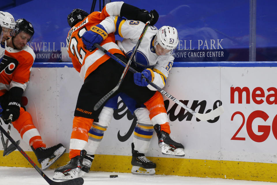 Buffalo Sabres forward Jeff Skinner (53) is checked by Philadelphia Flyers forward Scott Laughton (21) during the second period of an NHL hockey game, Sunday, Feb. 28, 2021, in Buffalo, N.Y. (AP Photo/Jeffrey T. Barnes)