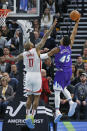 Utah Jazz guard Donovan Mitchell (45) lays the ball up as Houston Rockets forward P.J. Tucker (17) defends in the first half during an NBA basketball game Monday, Jan. 27, 2020, in Salt Lake City. (AP Photo/Rick Bowmer)