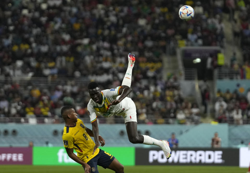 Ecuador's Carlos Gruezo, left, and Senegal's Pape Gueye vie for the ball during the World Cup group A soccer match between Ecuador and Senegal, at the Khalifa International Stadium in Doha, Qatar, Tuesday, Nov. 29, 2022. (AP Photo/Themba Hadebe)