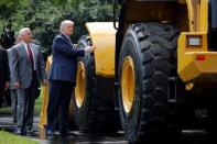 U.S. President Donald Trump and Vice President Mike Pence stand next to caterpillar equipment as they visit a "Made in America" products showcase at the White House in Washington, U.S., July 17, 2017. REUTERS/Carlos Barria