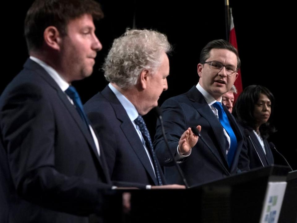 Conservative leadership candidate Pierre Poilievre gestures towards Jean Charest as Roman Baber, left, Scott Aitchison and Leslyn Lewis, right, look on during a debate at the Canada Strong and Free Network conference in Ottawa on May 5, 2022. (Adrian Wyld/The Canadian Press - image credit)