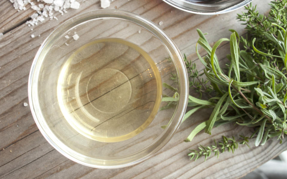 bowl of vinegar near the stove top with melted plastic