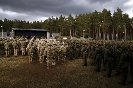 Polish and U.S. soldiers attend welcoming ceremony for U.S.-led NATO troops at polygon near Orzysz, Poland, April 13, 2017. REUTERS/Kacper Pempel