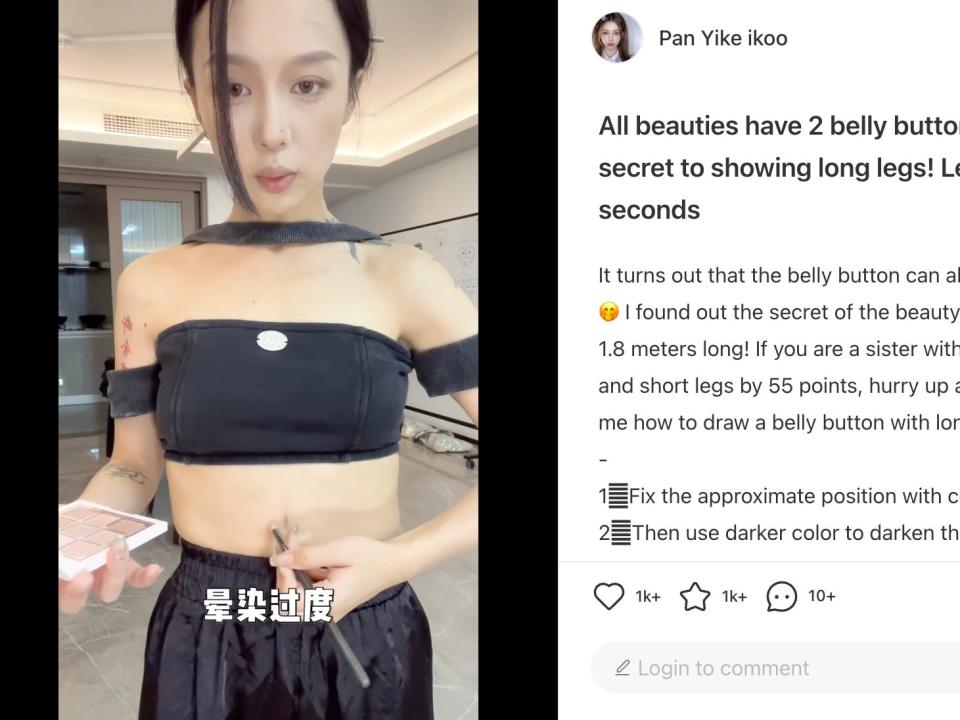A woman using makeup to draw a fake belly button.
