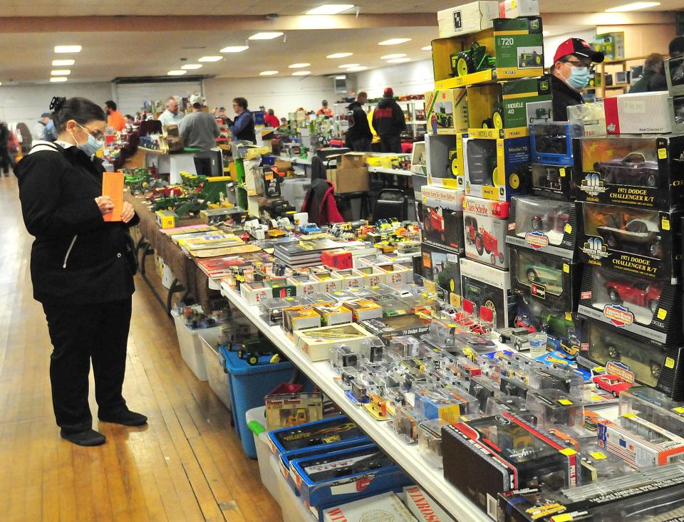 Betty Ryland, of Willard, looks at farm toys during the 2021 Ashland FFA Alumni Farm Toy Show. The gathering returns to the Ashland County Fairgrounds from 9 a.m. to 3 p.m. Dec. 19.