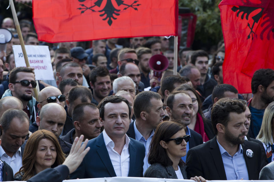 Albin Kurti, center, leader of Kosovo's opposition Self-Determination party leads the protest as opposition supporters hold banners and national Albanian flags march toward Skanderbeg Square on Saturday, Sept. 29, 2018, in Kosovo capital Pristina. Thousands of people in Kosovo are protesting their president's willingness to include a possible territory swap with Serbia in the ongoing negotiations to normalize relations between the two countries.(AP Photo/Visar Kryeziu)