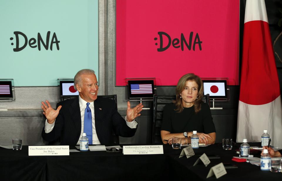 U.S. Vice President Joe Biden, flanked by U.S. Ambassador to Japan Caroline Kennedy, gestures as they meets with Japanese business leaders at the headquarters of internet commerce and mobile games provider DeNA Co. in Tokyo