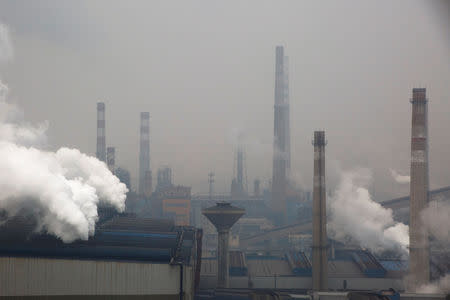 FILE PHOTO: Smoke and steam rise from a steel plant in Anyang, Henan province, China, February 18, 2019. REUTERS/Thomas Peter/File photo