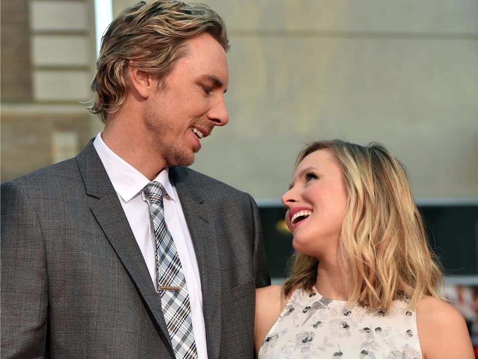 Kristen Bell and Dax Shepard smile at each other.