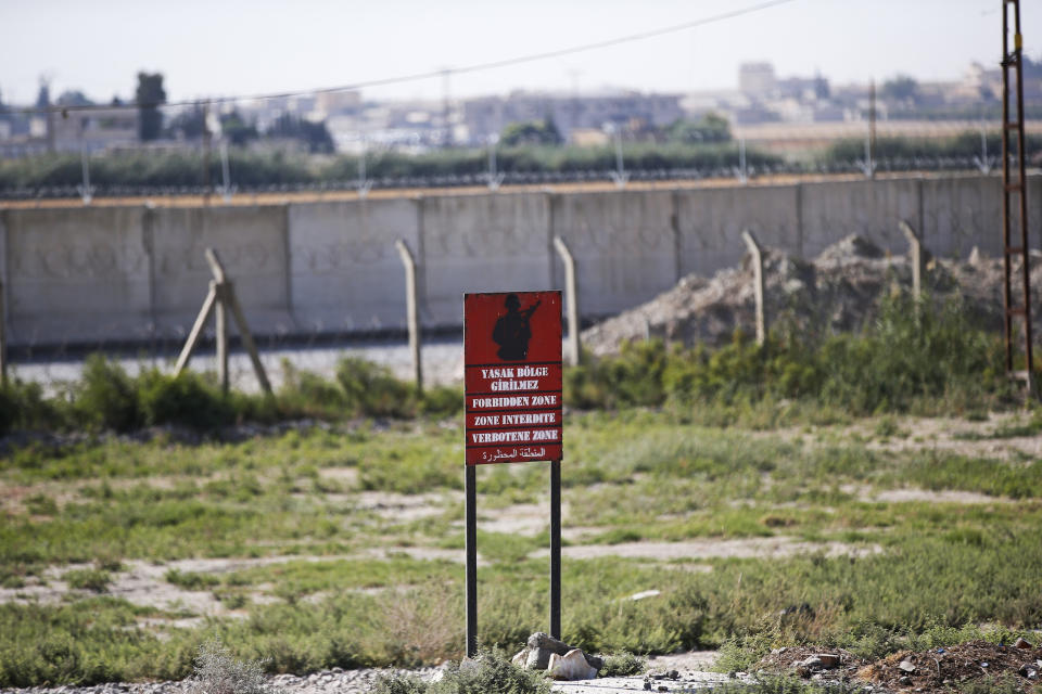 A view of the border between Turkey and Syria, in Akcakale, Sanliurfa province, southeastern Turkey, Tuesday, Oct. 8, 2019. The Turkey - Syria border has became a hot spot as Turkish Vice President Fuat Oktay said Turkey was intent on combatting the threat of Syrian Kurdish fighters across its border in Syria. (AP Photo/Lefteris Pitarakis)