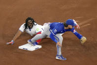 Toronto Blue Jays' Vladimir Guerrero Jr. (27) is forced out by Kansas City Royals shortstop Bobby Witt Jr. (7) on a double play in the fourth inning of a baseball game in Toronto, Wednesday, May 1, 2024. (Chris Young/The Canadian Press via AP)