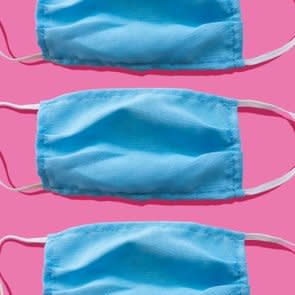 Blue medical face mask to avoid contagious diseases pattern on pink background