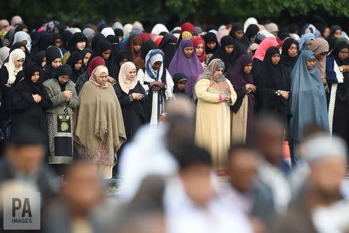 <span class="caption">Muslim women pray behind men at mass prayers to celebrate Eid al-Adha in Birmingham. </span> <span class="attribution"><span class="source">Joe Giddens/PA Archive</span></span>