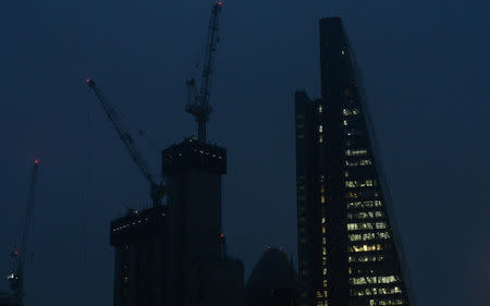 Office lights burn into the night in the City of London, Britain October 18, 2017. Picture taken October 18, 2017. REUTERS/Mary Turner