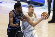 Dallas Mavericks forward Kristaps Porzingis (6) battles Sacramento Kings forward Chris Silva (30) for space during the half of an NBA basketball game, Sunday, April 18, 2021, in Dallas. (AP Photo/Brandon Wade)