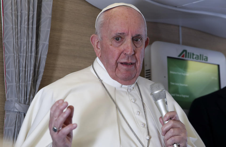 Pope Francis speaks to journalists, Monday, March 8, 2021, while flying back to The Vatican at the end of his four-day trip to Iraq where he met with different Christian communities and Shiite revered cleric Grand Ayatollah Ali al-Sistani. (AP Photo/Yara Nardi, pool)