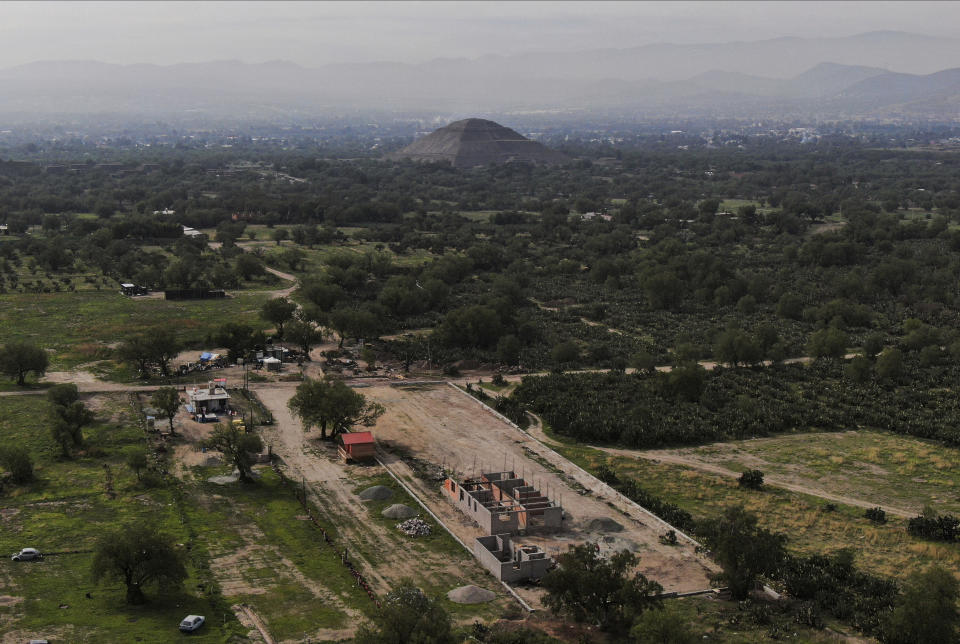 Construction of a private building project is seen on the outskirts of Teotihuacan, just north of Mexico City, Wednesday, May 26, 2021. The Mexican government said Tuesday that the project is destroying part of the outskirts of the pre-Hispanic ruin site and has repeatedly issued stop-work orders since March but the building crews have ignored them. (AP Photo/Fernando Llano)