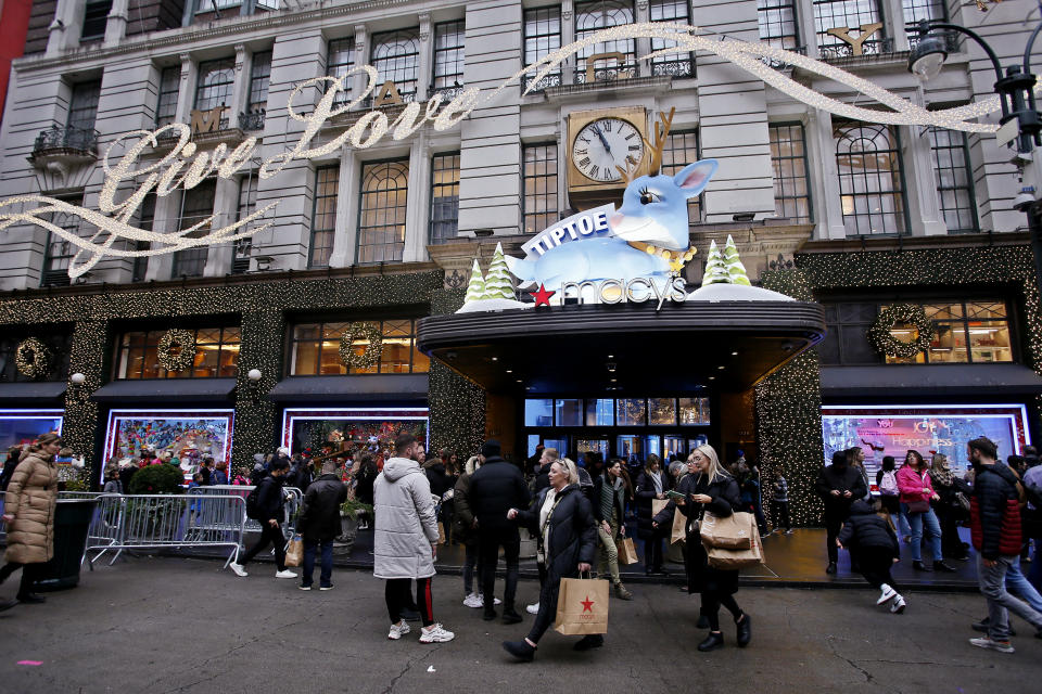 Holiday shoppers make their way past Macy's storefront in New York during Black Friday.