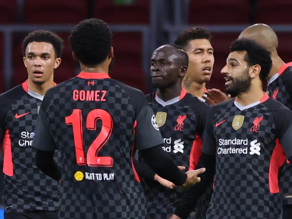 Liverpool players celebrate after Ajax scored an own goalAFP