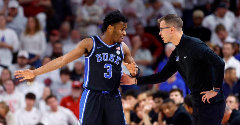 Duke’s Jeremy Roach (3) talks with head coach Jon Scheyer during the first half of Duke’s game against Arkansas at Bud Walton Arena in Fayetteville, Ark., Weds. Nov. 29, 2023.