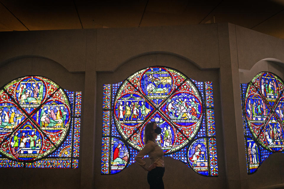 <p>A staff member at the British Museum in London looks at an entire 800-year-old stained glass window on loan from Canterbury Cathedral to the museum for a new "Thomas Becket: murder and the making of a saint" exhibition which runs May 20 to August 22, 2021, as the museum gets ready for the public ahead of further easing of lockdown restrictions in England. Picture date: Tuesday May 11, 2021.</p>
