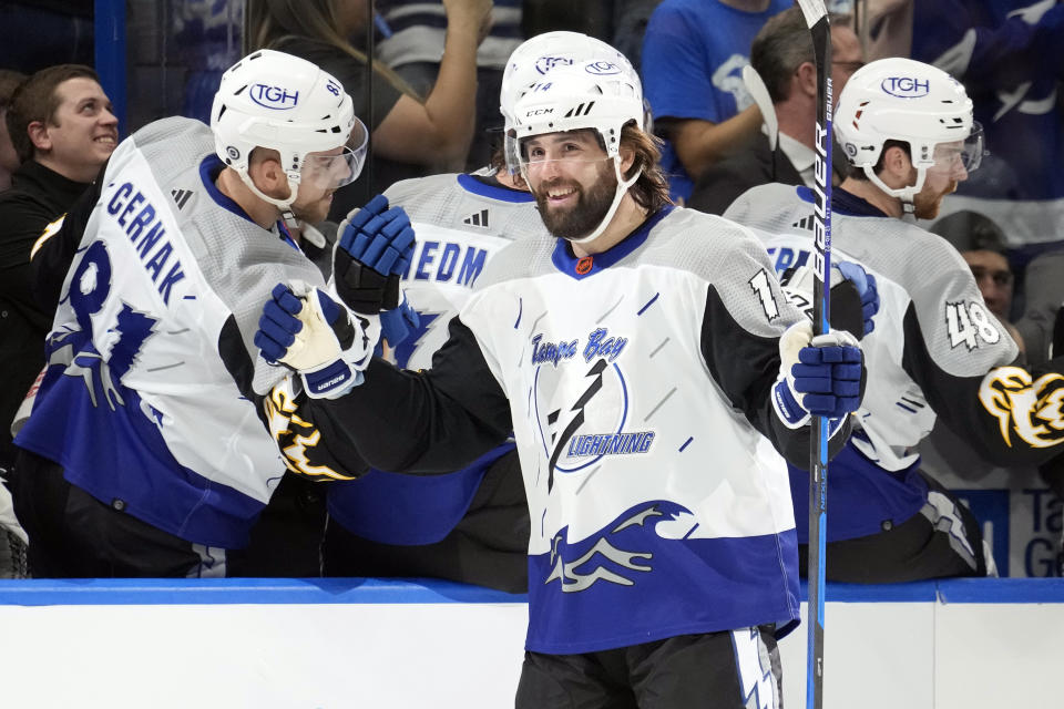 Tampa Bay Lightning left wing Pat Maroon (14) celebrates with the bench after his goal against the Florida Panthers during the first period of an NHL hockey game Saturday, Dec. 10, 2022, in Tampa, Fla. (AP Photo/Chris O'Meara)