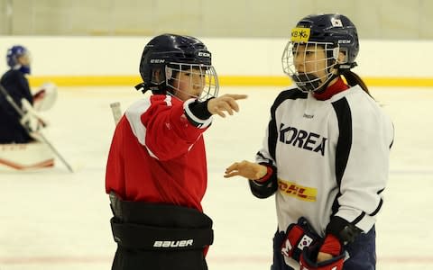 North and South Korean women's ice hockey athletes talk during training - Credit: Reuters