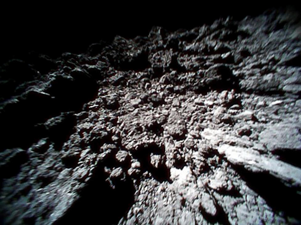 FILE - This Sept. 23, 2018 file image captured by Rover-1B, and provided by the Japan Aerospace Exploration Agency (JAXA) shows the surface of asteroid Ryugu. Japan’s space agency is delaying a spacecraft touchdown on an asteroid as scientists need more time to find a safe landing site on the extremely rocky surface. (JAXA via AP, File)