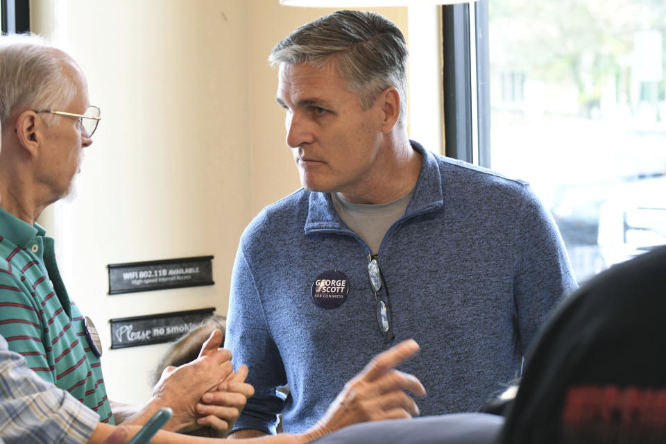 In this Saturday, Oct. 6, 2018 photo, George Scott, the Democratic candidate for Congress in a Republican-leaning seat in conservative central Pennsylvania, listens to volunteer canvassers while meeting with them, in Camp Hill, Pa. A court-ordered redrawing of Pennsylvania's House districts has forced several Republican congressmen into more competitive seats and helped establish Pennsylvania as a key state for Democrats aiming to recapture the House majority. (AP Photo/Marc Levy)