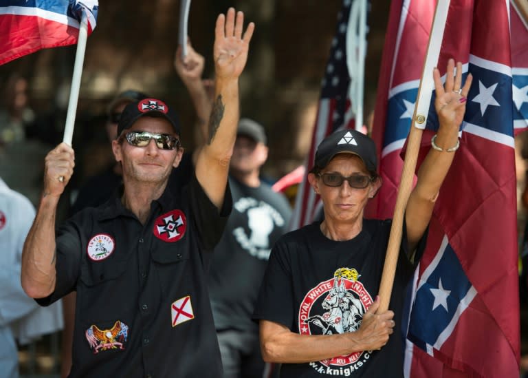 Members of the Ku Klux Klan salute during a rally in Charlottesville, Virginia on July 8, 2017