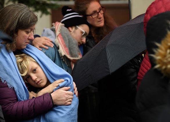 Mourners gather outside Pittsburgh synagogue where an anti-Semitic gunman opened fire.