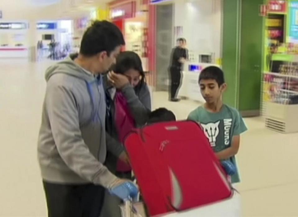 A passenger crying in the airport after the chaotic flight landed safely in Perth (AP)