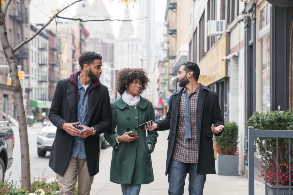 the people talking and walking down the street