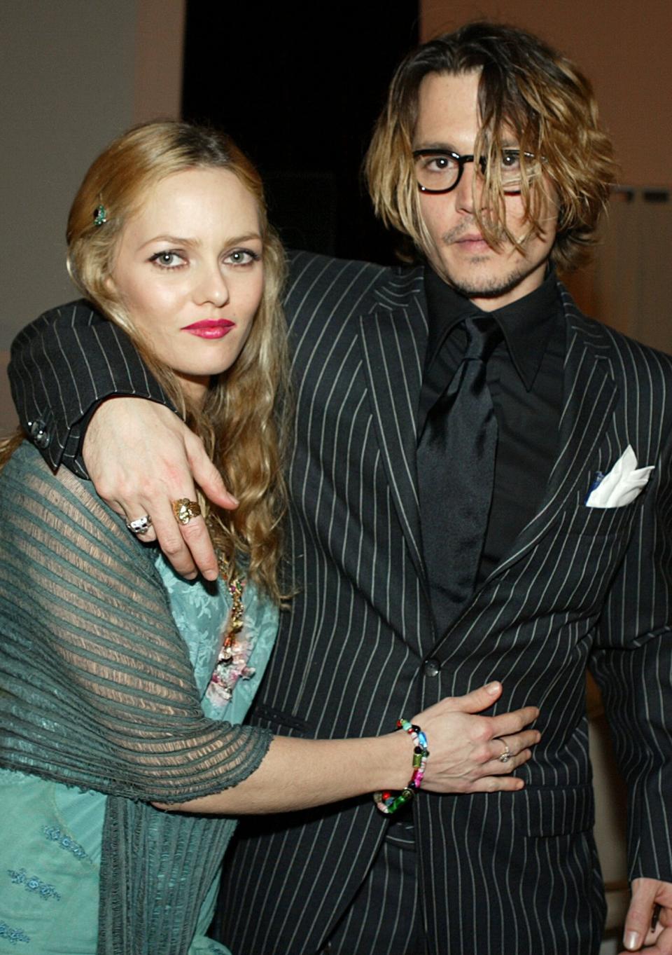 Johnny Depp (R) and girlfriend Vanessa Paradis pose after The 9th Annual Critic's Choice Awards at the Beverly Hills Hotel on January 10, 2004 in Beverly Hills, California