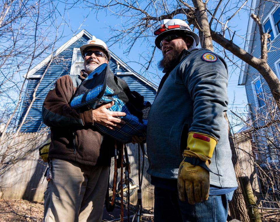 We Energies troubleshooters (left) Greg Stuckert and (right) Joel Frappier rescue a cat which had been stuck on a utility pole for an estimated three days in the Riverwest neighborhood on Thursday February 1, 2024 in Milwaukee, Wis.