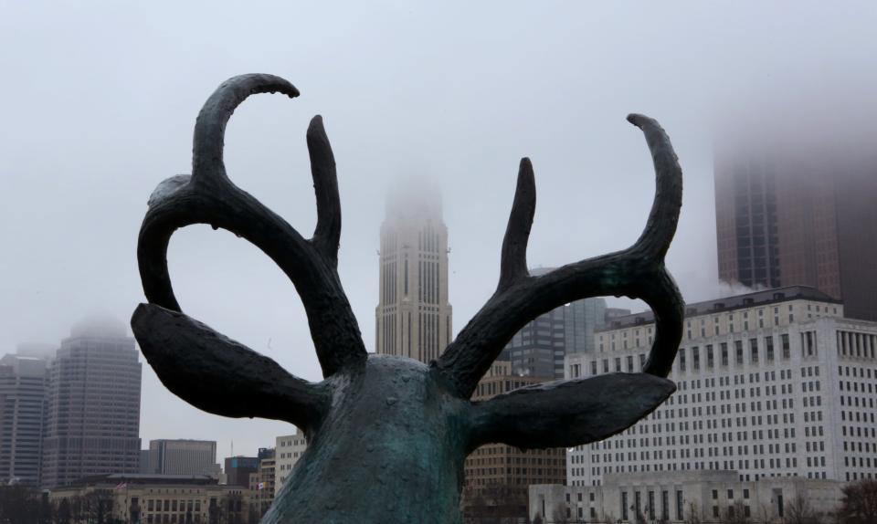 The city takes on a foggy look as seen through the deer sculptures antler on the W. Rich. St. January 8, 2015.