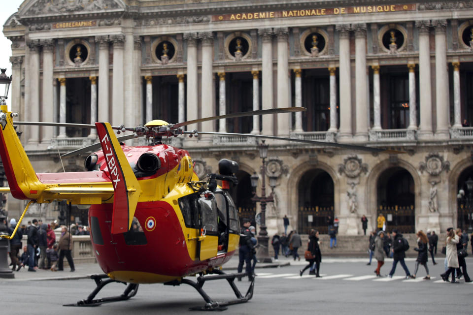 A rescue helicopter stands ready to evacuate wounded people in front of the Paris Opera House following a gas leak explosion, France, Saturday, Jan. 12, 2019. A powerful explosion and fire apparently caused by a gas leak at a Paris bakery Saturday injured several people, blasted out windows and overturned cars, police said. (AP Photo/Thibault Camus)