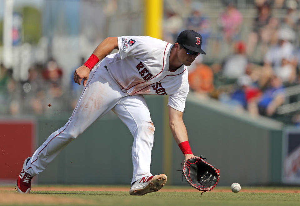 FILE - In this March 2, 2019, file photo, Boston Red Sox third baseman Bobby Dalbec reaches for the ball on a single by Baltimore Orioles' JC Escara during the fifth inning of a spring training baseball game in Fort Myers, Fla. Dalbec, who plays first and third base, could get the call if the team needs help at one of the infield corners. (AP Photo/Gerald Herbert, File)