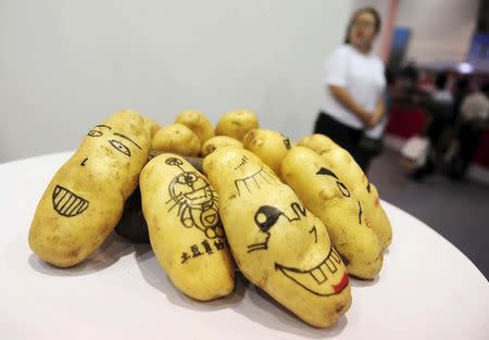 Potatoes painted with faces and cartoons are seen on display during the World Potato Congress on the outskirts of Beijing, China, July 28, 2015. REUTERS/Stringer