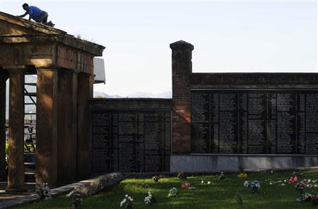 A man works at one of the entrances to the mass grave in civil zone of the cemetery San Salvador in Oviedo, northern Spain, September 23, 2013. REUTERS/Eloy Alonso