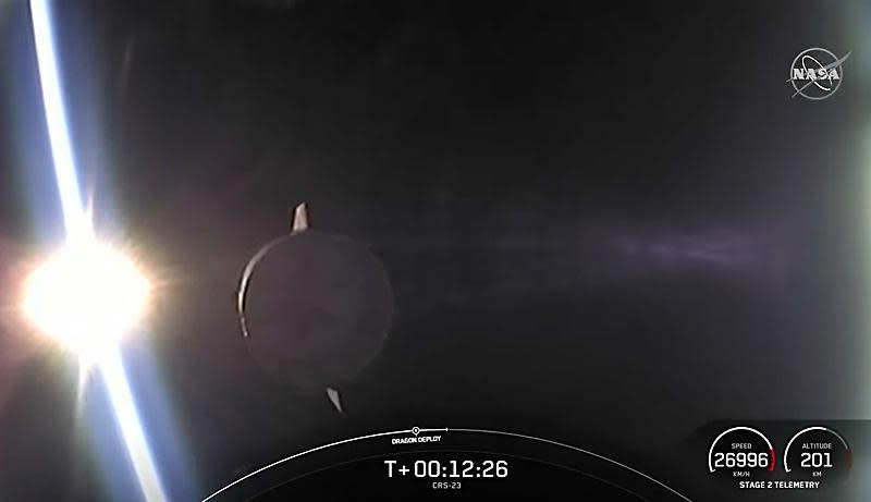 A camera on the Falcon 9's second stage captures a view of the SpaceX Dragon cargo ship flying toward the rising sun moments after release into its initial orbit. / Credit: NASA/SpaceX webcast