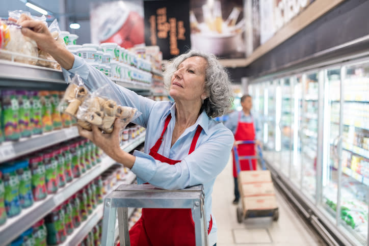 A retired woman works part time at a grocery store