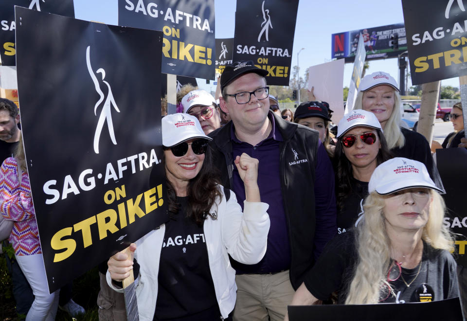 SAG-AFTRA president Fran Drescher from left, Duncan Crabtree-Ireland, SAG-AFTRA national executive director and chief negotiator, and actor Frances Fisher, right, take part in a rally by striking writers and actors outside Netflix studio in Los Angeles on Friday, July 14, 2023. This marks the first day actors formally joined the picket lines to strike, more than two months after screenwriters began striking in their bid to get better pay and working conditions. (AP Photo/Chris Pizzello)